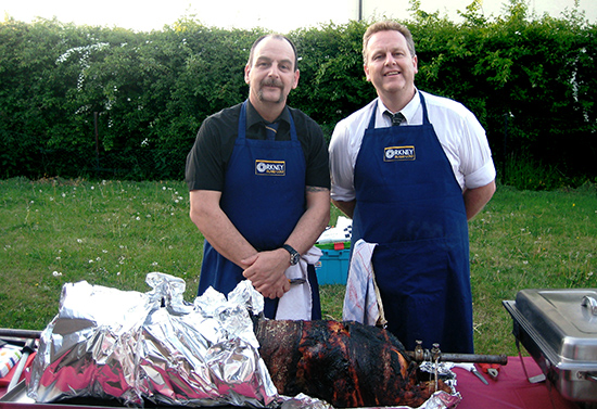 Buntings outside catering team cooking a hog roast